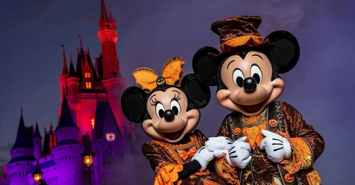 Mickey & Minnie im Halloweenkostüm Mickey und Minnie stehen in orange-schwarzen Halloweenkostümen vor dem Cinderella Castle im Magic Kingdom